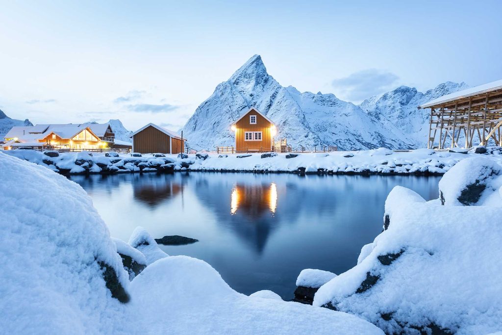 View on the house in the Sarkisoy village, Lofoten Islands, Norway. Landscape in winter time during blue hour. Mountains and water. Travel - image