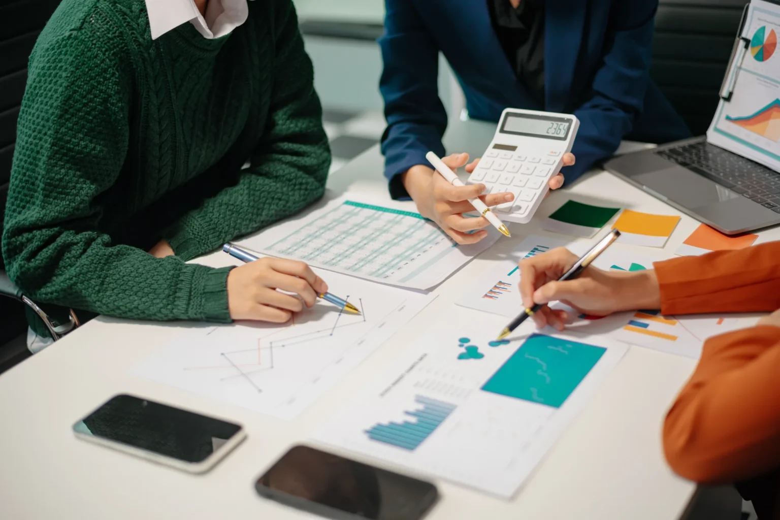 business-professionals-analyzing-data-charts-in-of-25LXMXY