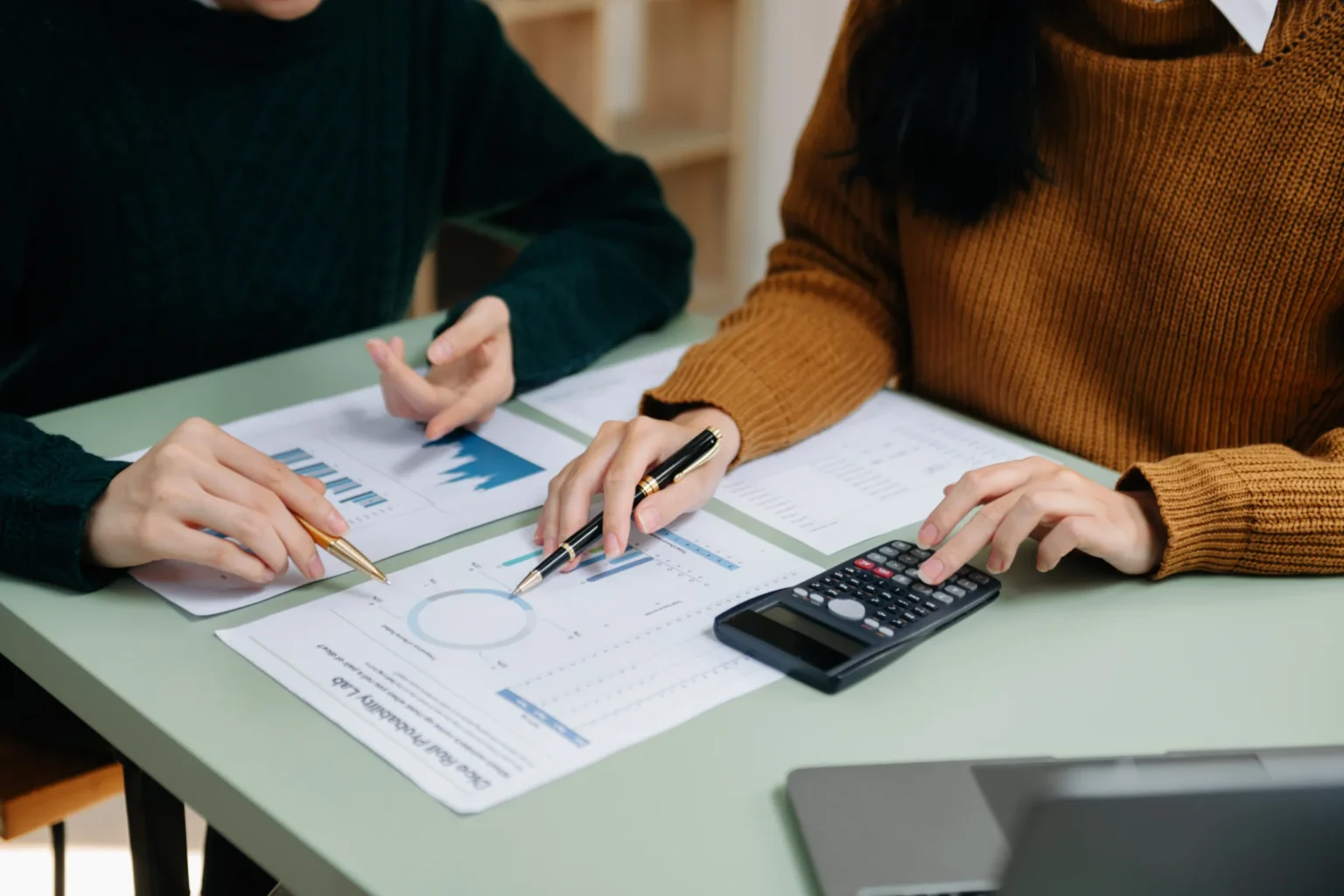 business-professionals-reviewing-data-and-using-ca-JPVDYVT