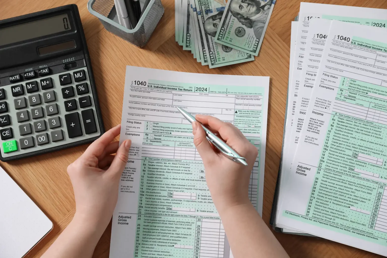payroll-woman-working-with-tax-return-forms-at-wo-7G2LBMX