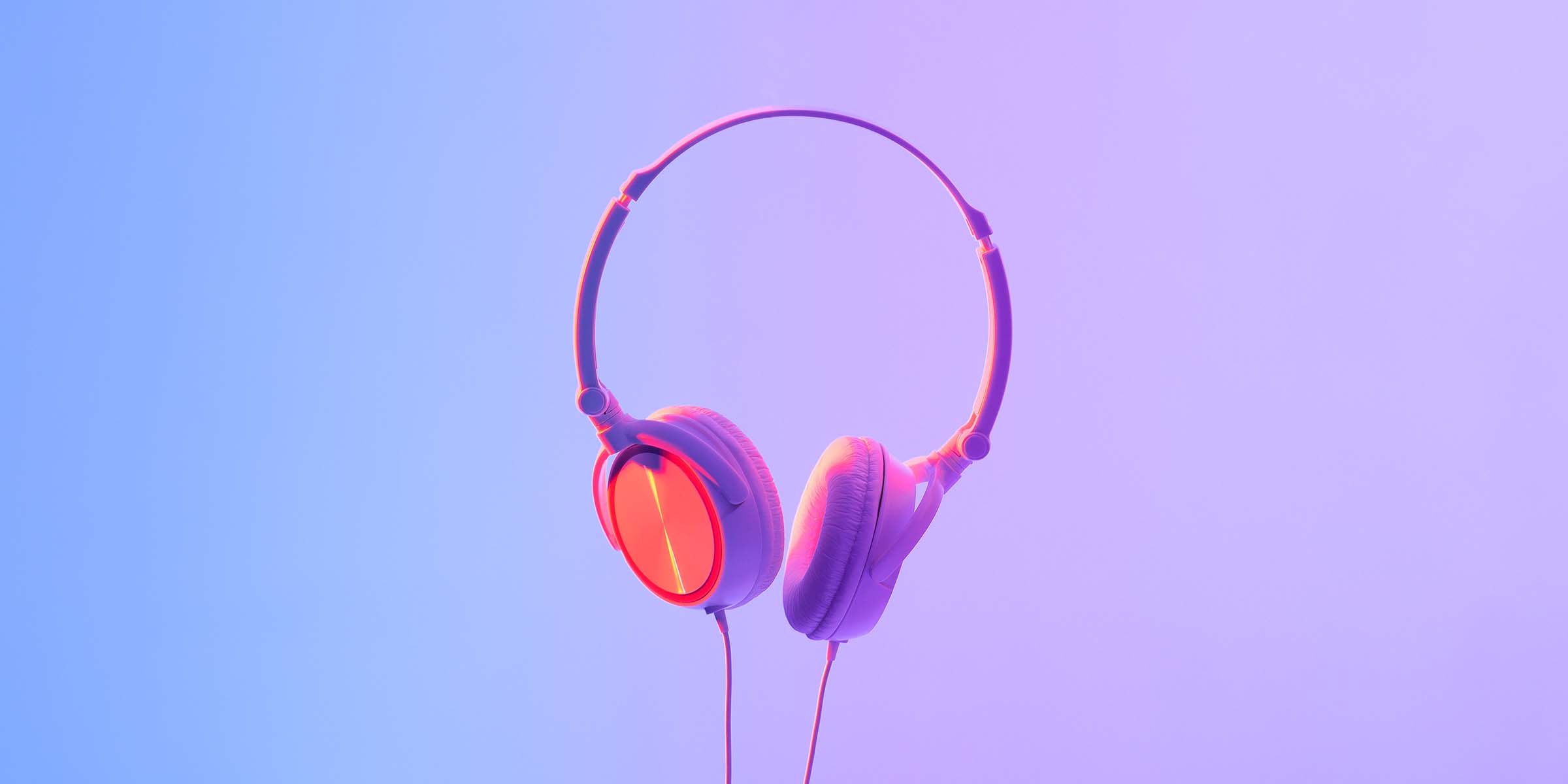 Modern gadget for hipster, technology, youth style, favorite music and device for relaxation in free time. White headphones hang in air, in neon, studio shot, flat lay, free space, cut out
