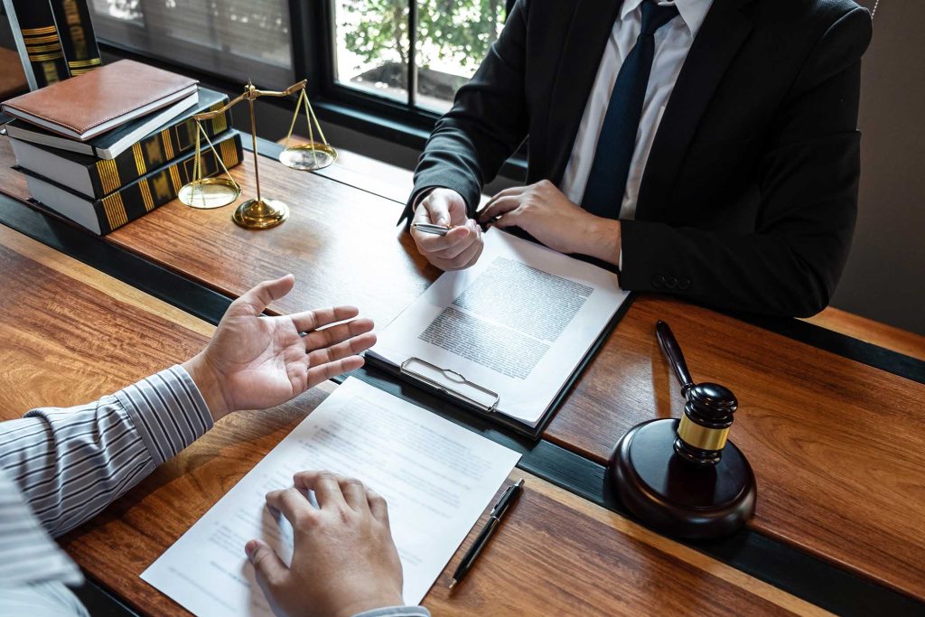 Professional male lawyer or counselor discussing negotiation legal case with client meeting with document contract in office, law and justice, attorney, lawsuit concept.