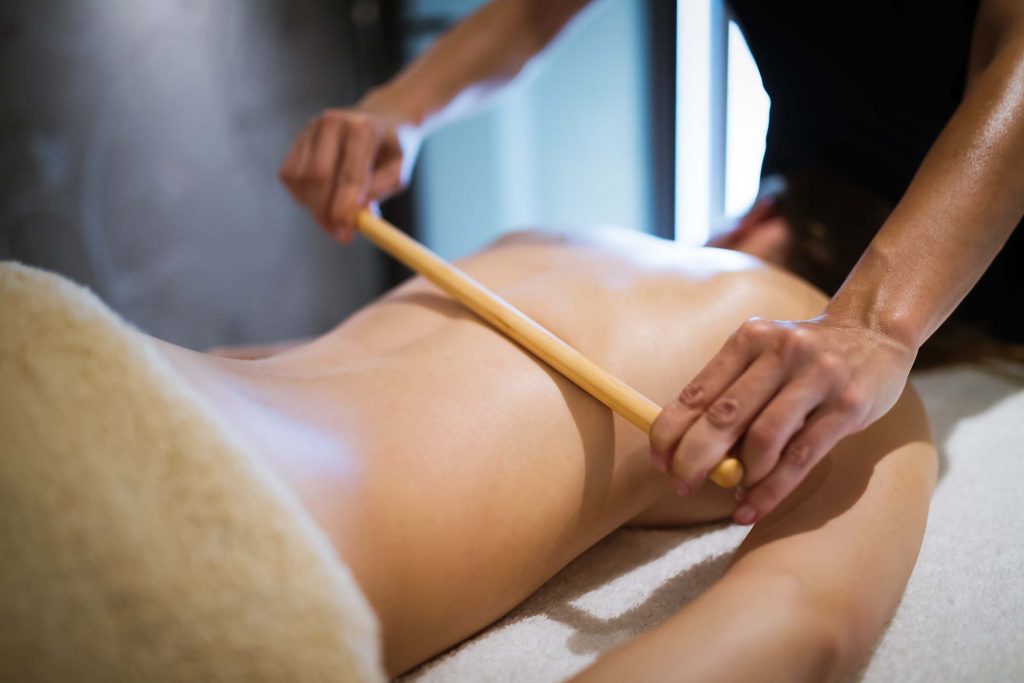 Masseur treating masseuse at spa wellness saloon