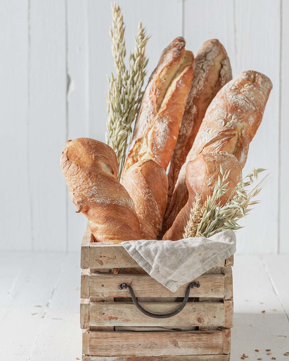 Rustic baguettes baked in bakery. Baguettes from the bakery. Pieces of baguette.