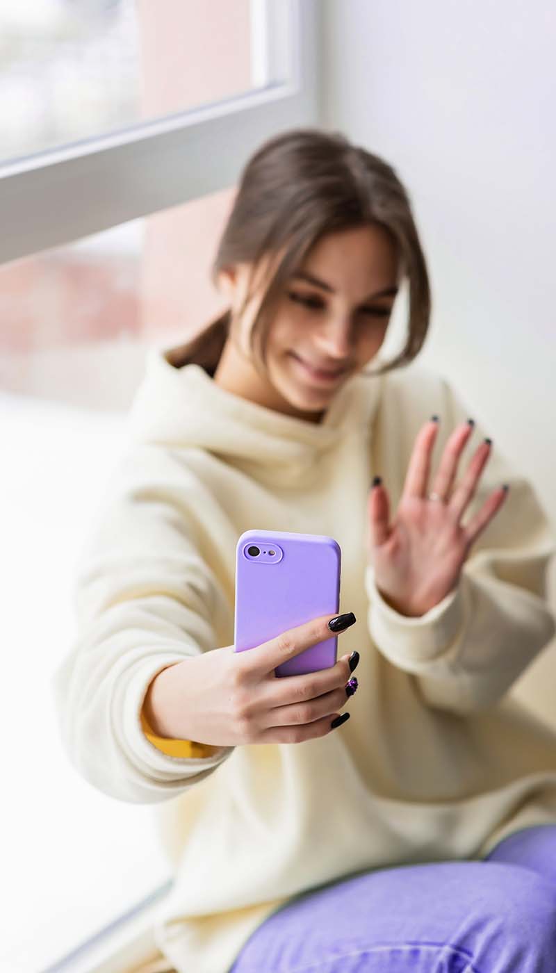 happy-female-blogger-taking-selfie-portrait-on-sma-JJ9WRFY