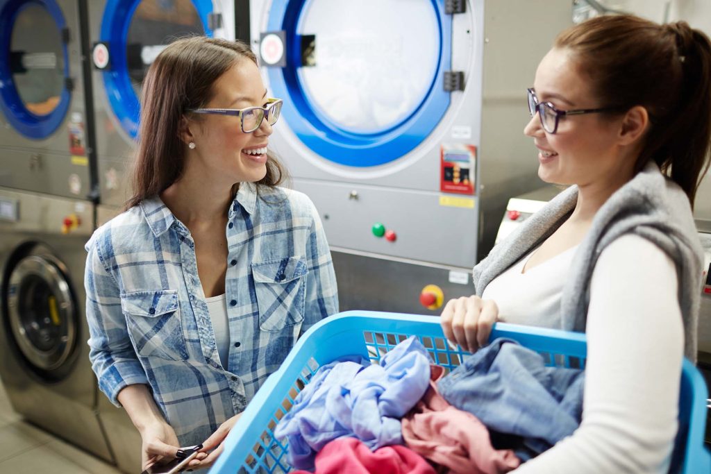 Two friendly girls met in laundry