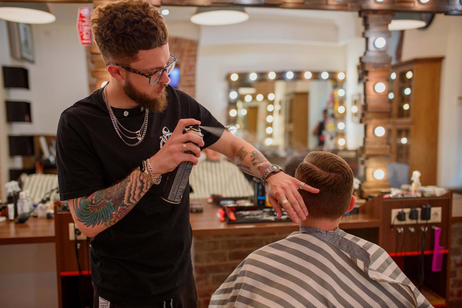 02/20/2020 Ukraine, Lviv: A barber man is styling a businessman in a barbershop.