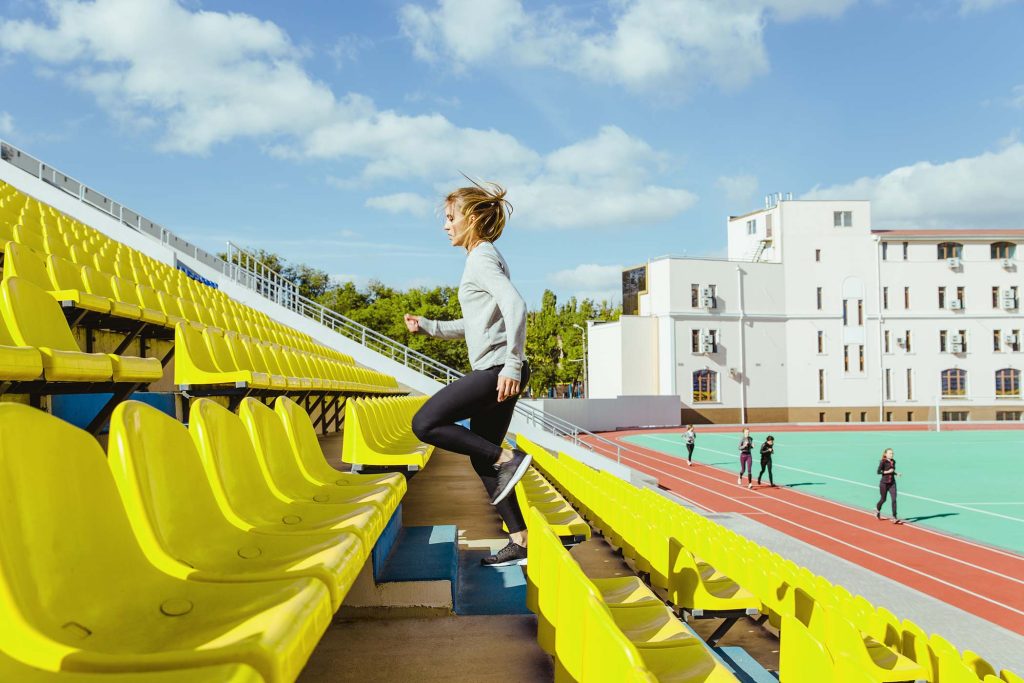 Portrait of a sports woman running at stadium