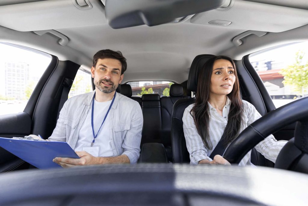 Unconfident millennial pretty woman driving car for first time with instructor handsome man giving her advices and tip. fear of driving concept. Scared lady attending driving school