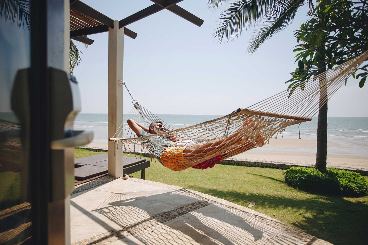 Couple relaxing in a hammock by the beach