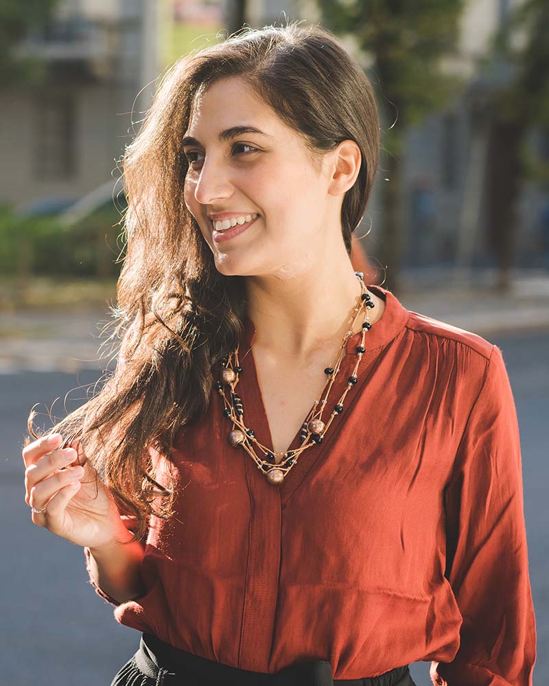 Portrait young brunette woman outdoor overlooking smiling