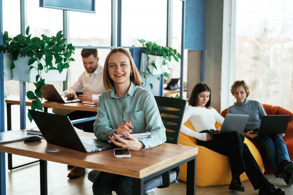 Positive and cheerful mood. People are working in the office with bean bags chairs in it.